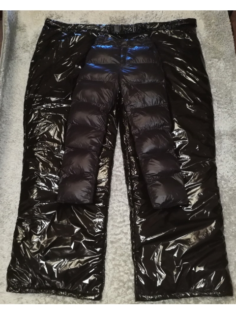 Shiny black ski pants laying on white bed on Craiyon